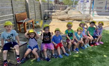 Some of the Boothbay Region YMCA’s Harbor Montessori School summer friends are excited to a helping hand in the natural playground while their school is being renovated behind them. The Harbor Montessori School is scheduled to open up on-time and on-budget at the end of August. Courtesy of Allyson Goodwin