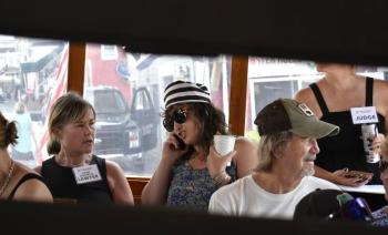 Behind bars, Library Executive Director Joanna Breen calls friends to raise bail money. ISABELLE CURTIS/Boothbay Register