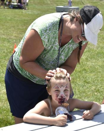 Gwendolyn Watts, 7, won the kids pie eating contest with encouragement from her mother, Kim Watts. FRITZ FREUDENBERGER/BOOTHBAY REGISTER