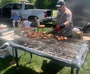 Ed Harmon Jr. is kept busy barbecuing chicken during the Aug. 2 Boothbay V.E.T.S. fundraiser. BILL PEARSON/Boothbay Register EHJ