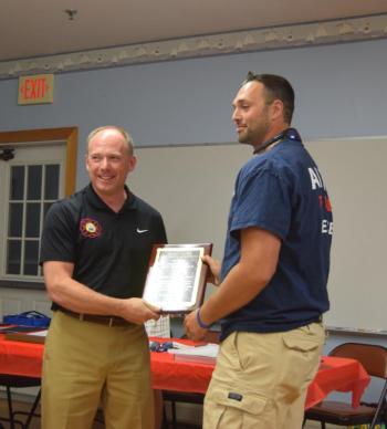 Waldoboro Fire Chief Paul Smeltzer, left, presents Alna firefighter Bret Butterfield with the Firefighter of the Year Award during the Lincoln County Fire Chiefs Association’s annual meeting on Wednesday, Aug. 20. Christina Wallace photo Smeltzer