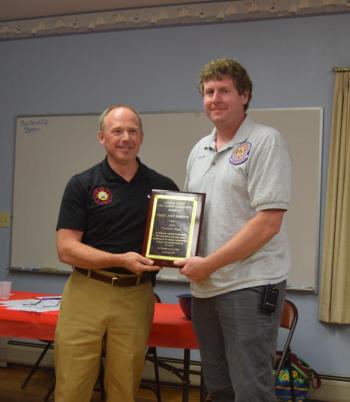 Damariscotta Fire Chief John Roberts, right, receives the 2024 President’s Award from Waldoboro Fire Chief Paul Smeltzer on Wednesday, Aug. 20. Smeltzer said Roberts' commitment to his department while managing the fire academy was among many reasons for his recognition. Christina Wallace photo Roberts