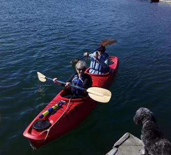 Joan McCabe’s dog Jessie cheers her and her sister-in-law on before they start paddling at a recent Rowgatta.  Courtesy of Bruce Washburn