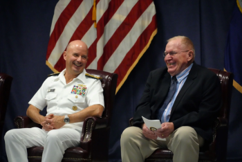 Capt. (ret) Floyston "Bud" Weeks, sits next to Adm. Jim Kilby, Acting Chief of Naval Operations, during his retirement ceremony at SWSC Newport, Naval Station Newport, R.I., July 18, 2025. John Goulette photo