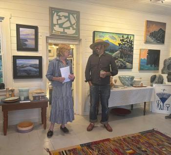 Diana Kerr introduces artist Matt Barter to the group attending the opening reception of "Oil Paint & Brimstone," a show of Matt and his father, the late Philp Barter's work. LISA KRISTOFF/Boothbay Register Diana Kerr introduces artist Matt Barter to the group attending the opening reception of "Oil Paint & Brimstone," a show of Matt and his father, the late Philp Barter's work. LISA KRISTOFF/Boothbay Register