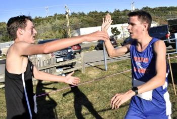 Lisbon's Malachi Ganong, right, and Boothbay's AJ Crocker congratulate each other at the finish line. Ganong won the boys race. FRITZ FREUDENBERGER/Boothbay Register