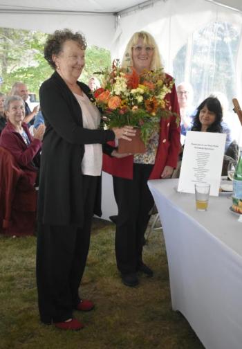 Sally Sewall receives flowers in thanks from BRHS. Pictured: Sally Sewall and BRHS Outreach and Development Manager Connie Hart.  ISABELLE CURTIS/Boothbay Register