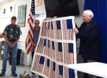 Brigadier General (Ret) William Leszczynski (right) receives a quilt at appreciation event. JANE CARPENTER/Boothbay Register