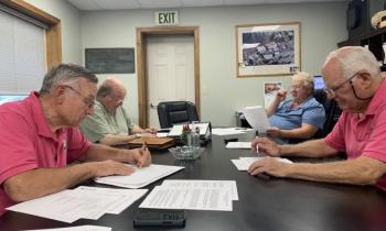 Boothbay Harbor Sewer District trustees overlook their draft agreement with Coastal Maine Bontantical Gardens. Pictured, from left: Russell Hoffman, Jim Stormont, Chris Higgins and Deryl Kipp. 