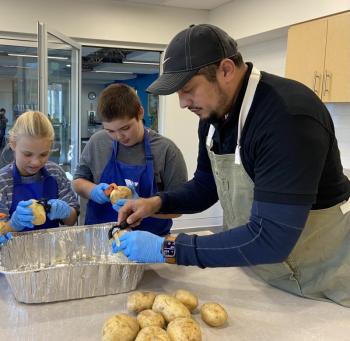 Preparing potatoes with Ivan Flores. Courtesy of Allyson Goodwin