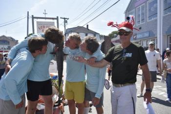 Schmakers Bay (BHYC) members yuk it up for this year's winning fish relay team photo as Jack Herger (FWJD) presents them with the $100 prize. LISA KRISTOFF/Boothbay Register