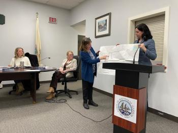 Lauren Stockwell, center, and Joana Tourangeau, far right, present a plan for a float project at 49 Atlantic Avenue to the Boothbay Harbor Selectboard Dec. 8. FRITZ FREUDENBERGER/Boothbay Register