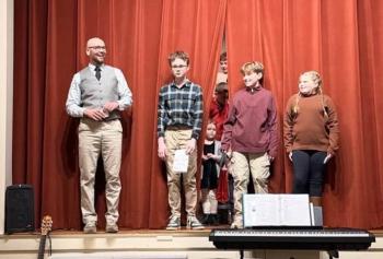 Principal Shawn Gallagher with sixth grade students, from left, Jonah Fessenden, Shepard Griffith and Aurora Wallace. Courtesy of Eileen Higgins/SCS