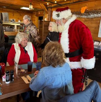 Santa visits a table.