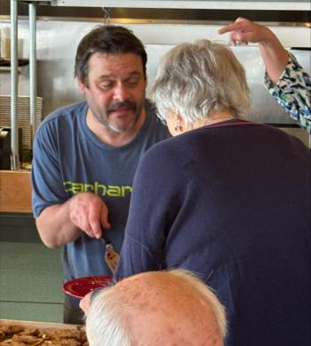 Earl Brewer serves up his amazing stuffed pork loin.