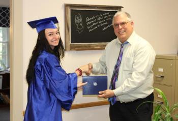 2023 Boothbay HiSET graduate Kyra Blake shakes hands with Alternative Organizational Structure (AOS) 98 Superintendent Robert Kahler. Courtesy of Raye Leonard