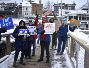 Locals walk down the footbridge in Boothbay Harbor as part of the national "Free America" protest. ISABELLE CURTIS/Boothbay Register