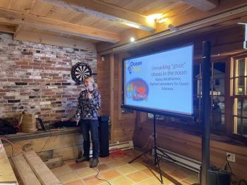 Ocean on Tap co-organizer, and Bigelow Laboratory Postdoctoral Fellow Alaina Weinheimer, discusses marine viruses at the inaugural Wiscasset edition of Ocean on Tap at Aekeir Brewing on Jan. 23. Courtesy of Bigelow Laboratory