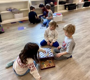 Lilly Albaum, Arbor Pascall, and Bayard Newton play some chess during quiet time at the Y’s Fit Kids Vacation Camp. Courtesy Allyson Goodwin