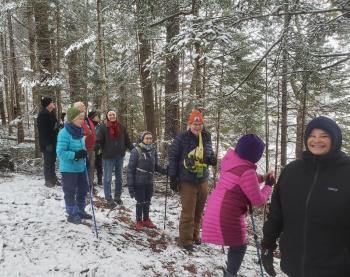 Hikers trek through a hemlock forest alongside the Pemaquid River at Keyes Woods Preserve in Bristol. Courtesy of Coastal Rivers