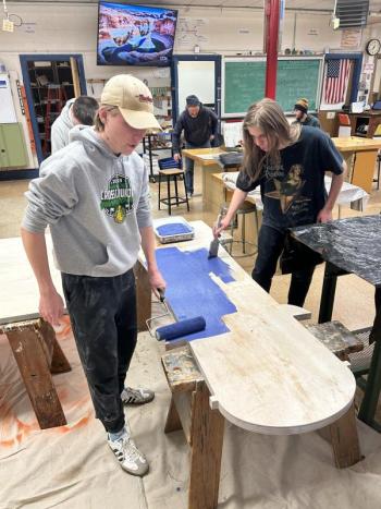 Nathan Percival and Preston Giles (right) apply a fresh coat of paint. Courtesy of Chris Liberti.
