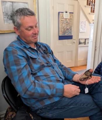 A participant tries on a sailmakers sewing glove. FRITZ FREUDENBERGER/Boothbay Register