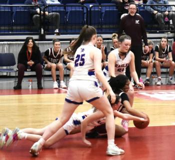 Surrounded by Eagles Hall fights to keep position of the ball. LISA KRISTOFF/Boothbay Register