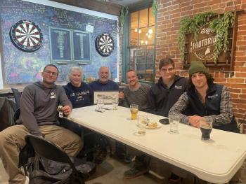 Trivia winners: The winning team poses with their victory plaque after the Ocean on Tap second anniversary trivia night at Footbridge Brewery on Feb. 19. Courtesy of Bigelow Laboratory