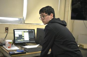 Brandon Seigers checks over the design. ISABELLE CURTIS/Boothbay Register