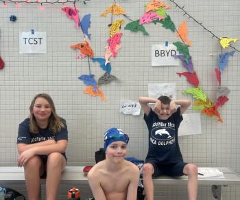 Three YMCA Dolphin swim team members at states. Courtesy of Emily LeGree 