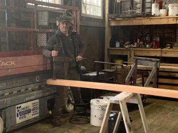 Carpenter Drake Loomis shows off a sealing clamp, used to wedge planks together. ISABELLE CURTIS/Boothbay Register