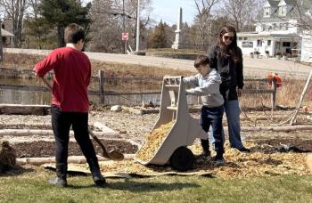 Students at Southport Central School lay cardboard and wood chips to create paths in preparation for another planting season at the community garden. Courtesy of Shawn Gallagher 