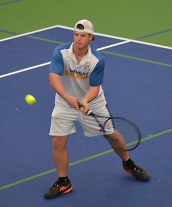 Griffin Yereance makes a backhand return against his Madison opponent. KEVIN BURNHAM/Boothbay Register