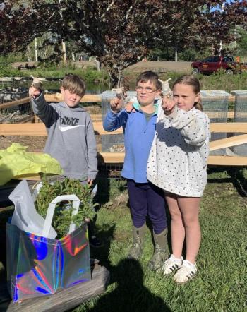 CMBG's Beth Jarvis gifts the Questers snail finger puppets for their hard work. ISABELLE CURTIS/Boothbay Register