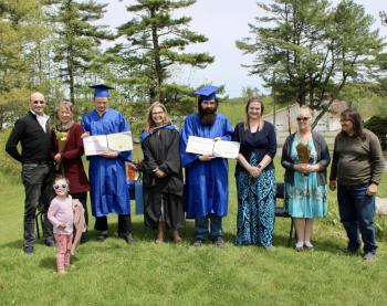 Friends and family join Boothbay-Wiscasset Regional Adult Education graduates, Larsson Lugg, of Palermo, left, and David Shaw, of Westport Island as they celebrated their graduation on May 23, at Wiscasset Middle High School. Courtesy photo