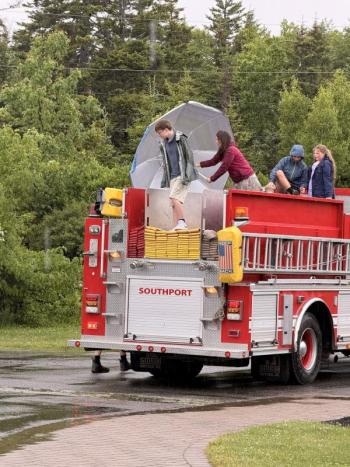 Teacher and graduates arrive at Newagen Inn via a fire truck. Eileen Higgins photo