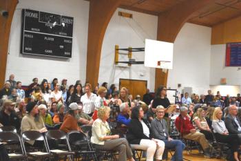 A line of community members of all ages wait to share personal stories and opinions during a forum to discuss MaineHealth Lincoln Hospital’s labor and birth unit at Great Salt Bay Community School in Damariscotta on Tuesday, June 2. Hospital officials expect to make a decision about the future of the unit in by August. (Emily Bracher photo)