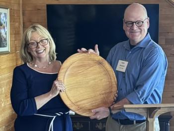 Holly Stover accepting a commemorative plaque from Keith Metrich, Chair, LCDC at awards ceremony. Courtesy photo