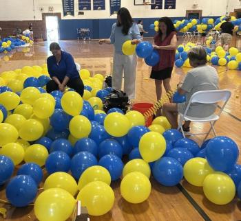 Busy as can be blowing up balloons on June 9. KEVIN BURNHAM/Boothbay Register