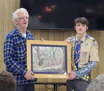 Former Scoutmaster Chris Roberts presents a Maurice Day print to Jeffrey McKinney, Eagle Scout, at the June 18 ceremony. Courtesy photo