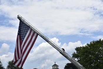 This man climbs down carefully after unfurling the flag,  Chris and Dave Gagne. LISA KRISTOFF/Boothbay Register
