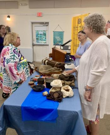 Guests peruse a typical travel pack of a Continental soldier. ISABELLE CURTIS/Boothbay Register