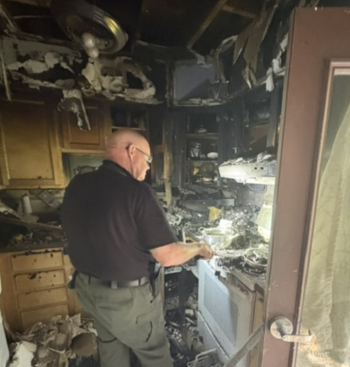 State Fire Marshal Ken MacMaster investigates the cause of a fire at the Campbell Apartments. Mark Sullivan photo