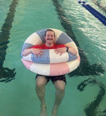 David Washburn floating in the pool after teaching a swim lesson. Courtesy of Emily LeGree
