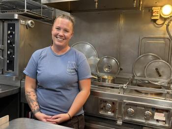Shelby Mann, who participated in one of SEA's college programs, now helps students in the kitchen.  ISABELLE CURTIS/Boothbay Register