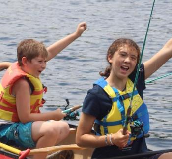 The Y’s mission in action: boating and fishing at Camp Knickerbocker this summer, just one of so many opportunities for children at the Y. Courtesy of Camp Knickerbocker summer camp staff