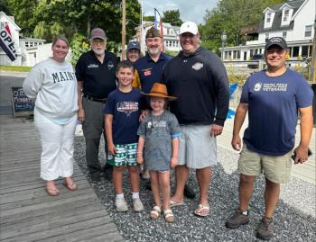 Winners of raffle and members of the VFW. Pictured from left, Megan Gill, Ed Harmon, Kiki, Brad Drummond, Brendan Gill, Justin Morgan; children, Emily and Liam. Courtesy of Jen Mitchell
