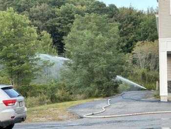 Water is dispersed onto the propane tanks and area behind the Meadow Mall. Mark Sullivan photo
