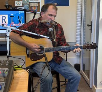 In addition to his guitar and footboard, Schwehm also incorporates harmonica into his performances. ISABELLE CURTIS/Boothbay Register