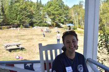 A father and son play volleyball on the lawn just over Danielle's shoulder. LISA KRISTOFF/Boothbay Register